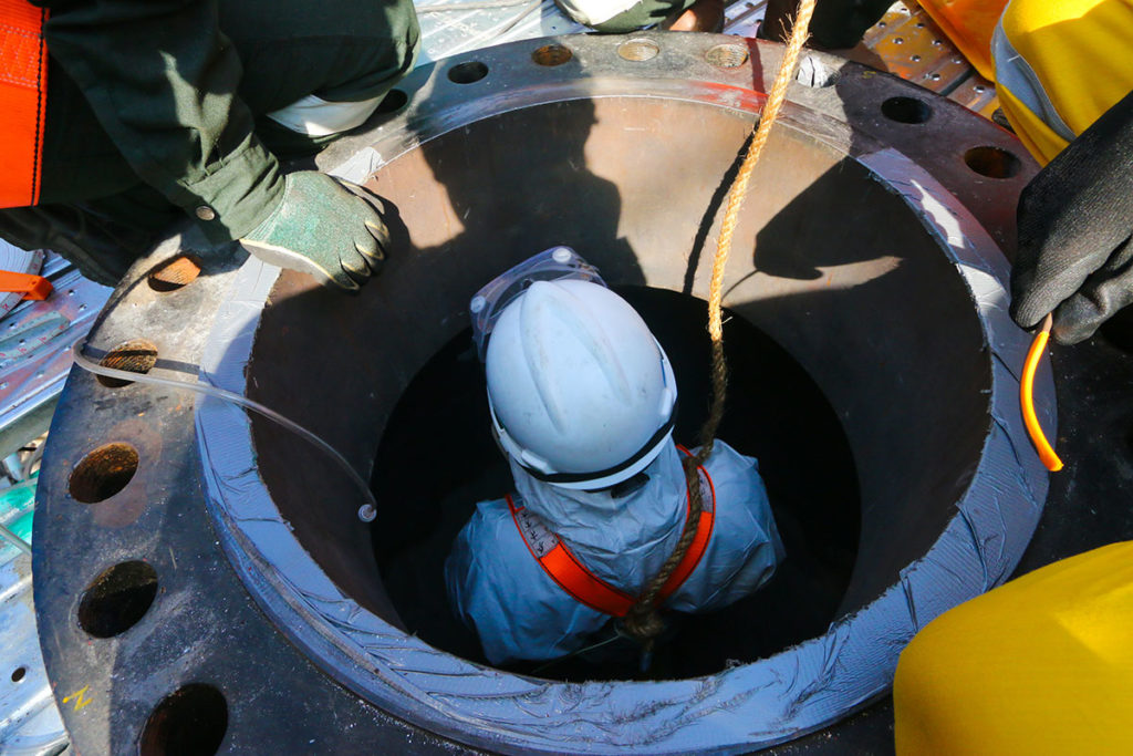 confined-space-entry-course "man going thorugh a confined space"